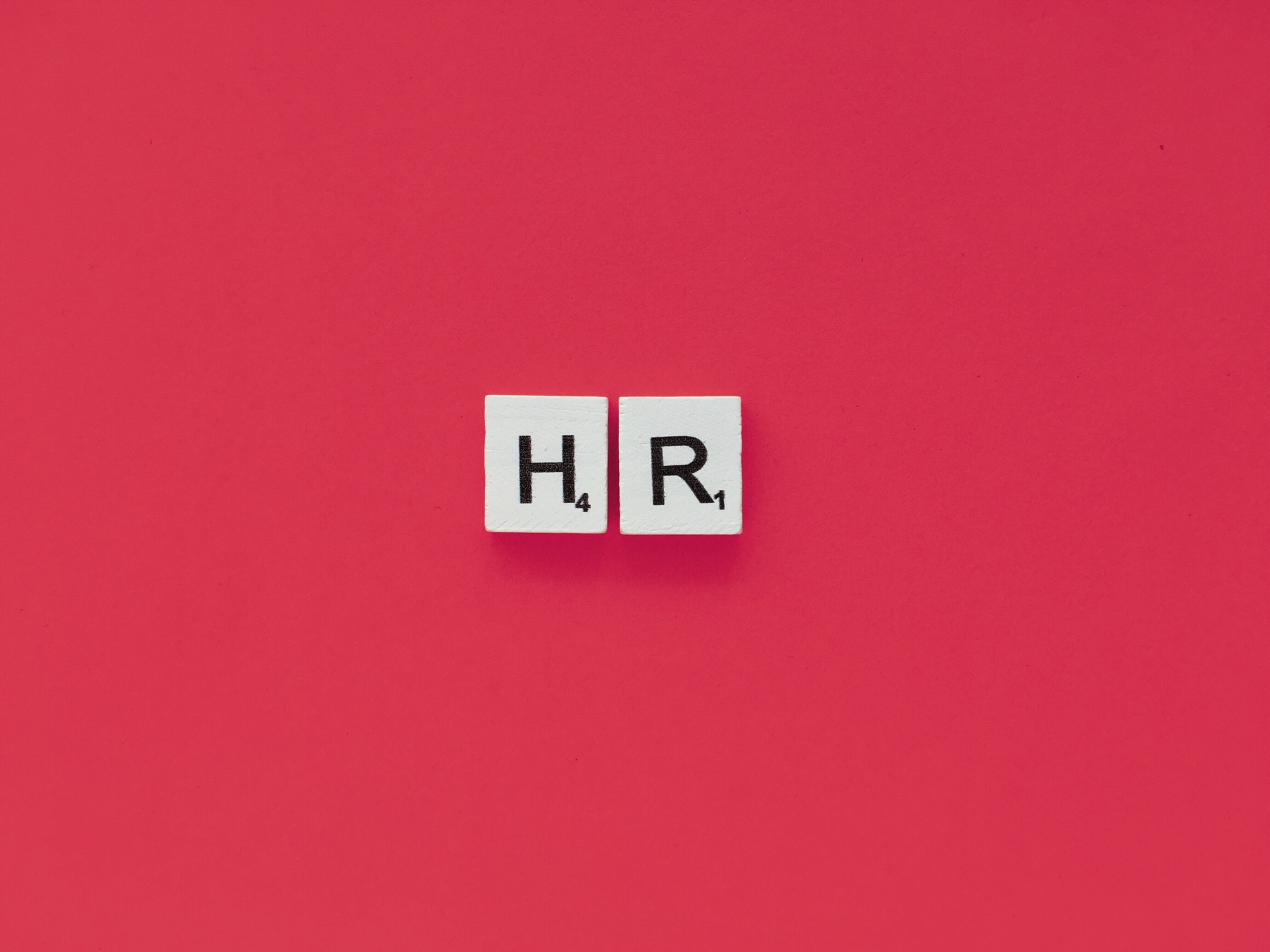 HR scrabble letters word on a pink background